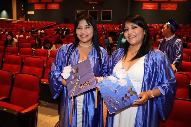 two women in caps and gowns at graduation
