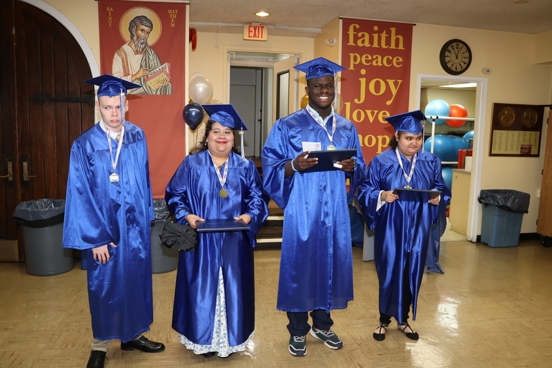 four of the graduates proudly show off certificates