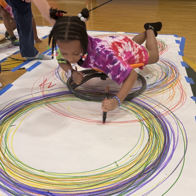 student works on large paper circle drawings