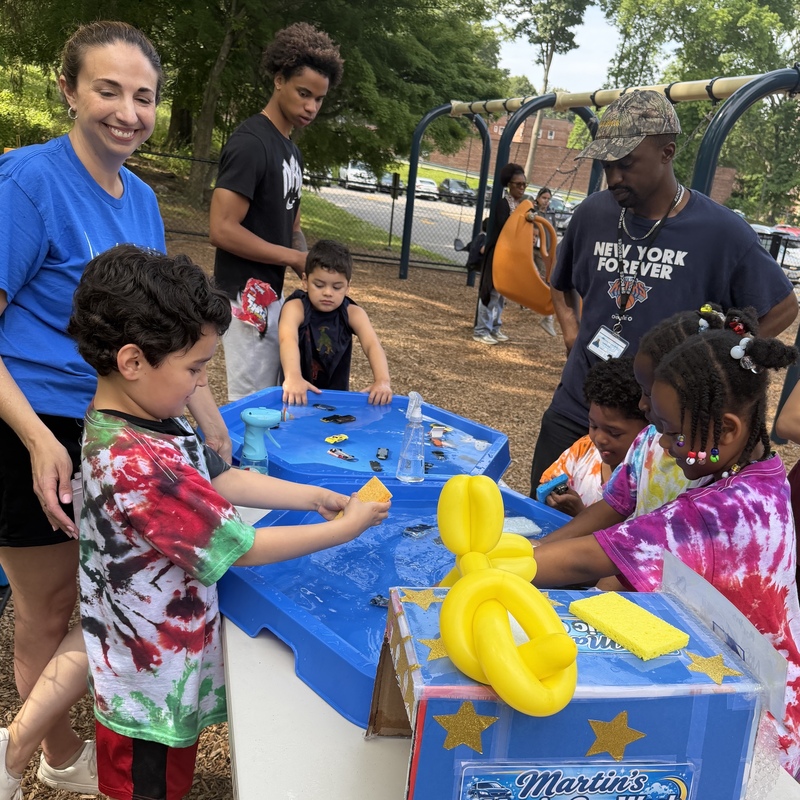 teachers make balloon animals for students