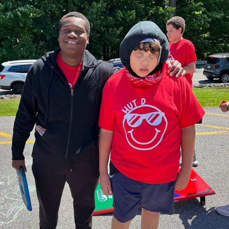 teacher and student smiling outside