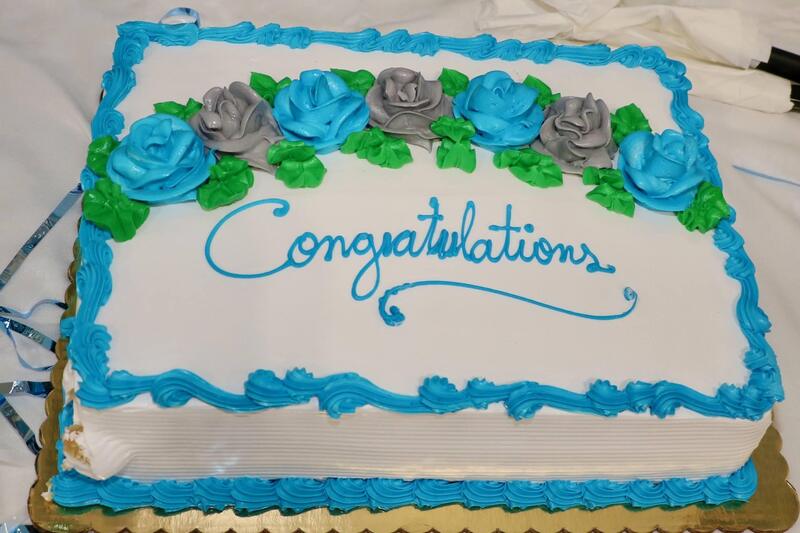 blue, green, gray and white sheet cake with Congratulations written on it