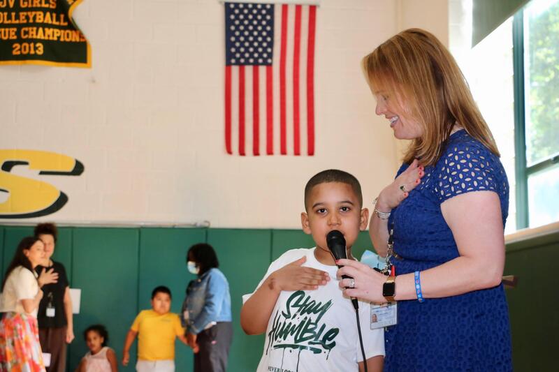 principal and student lead room in pledge of allegiance
