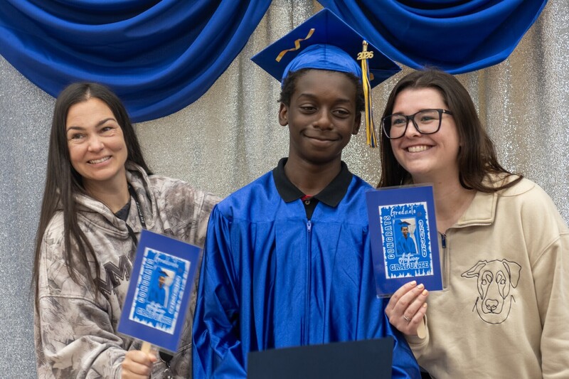 teachers celebrate with graduate