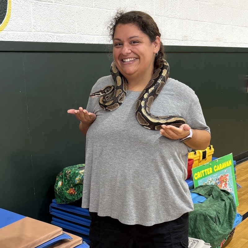 teacher has snake over her shoulders