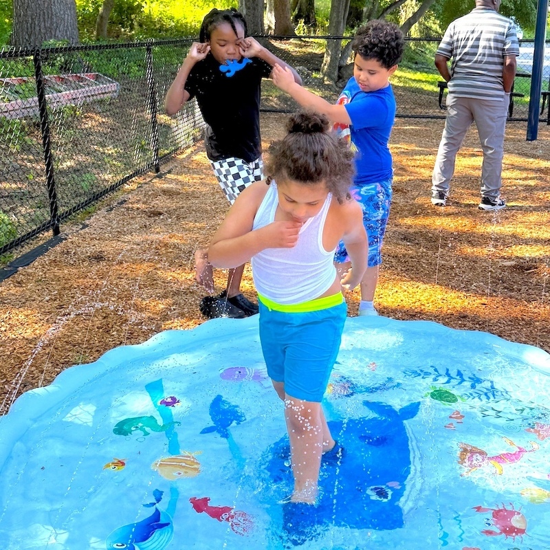students play on playground splash pad