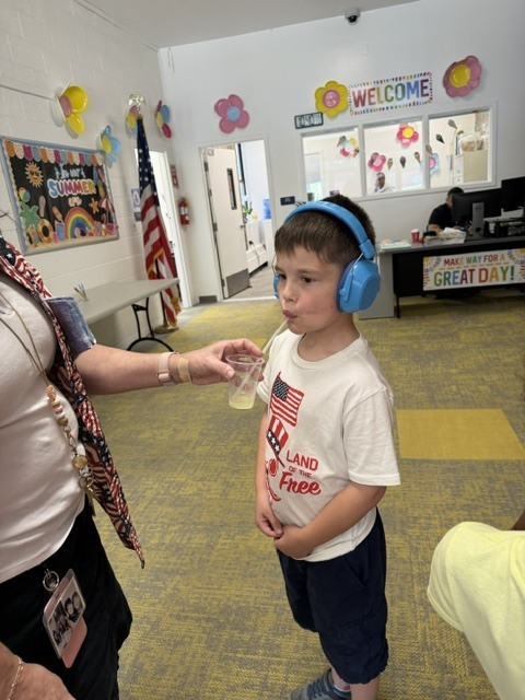 student enjoys classmates' lemonade