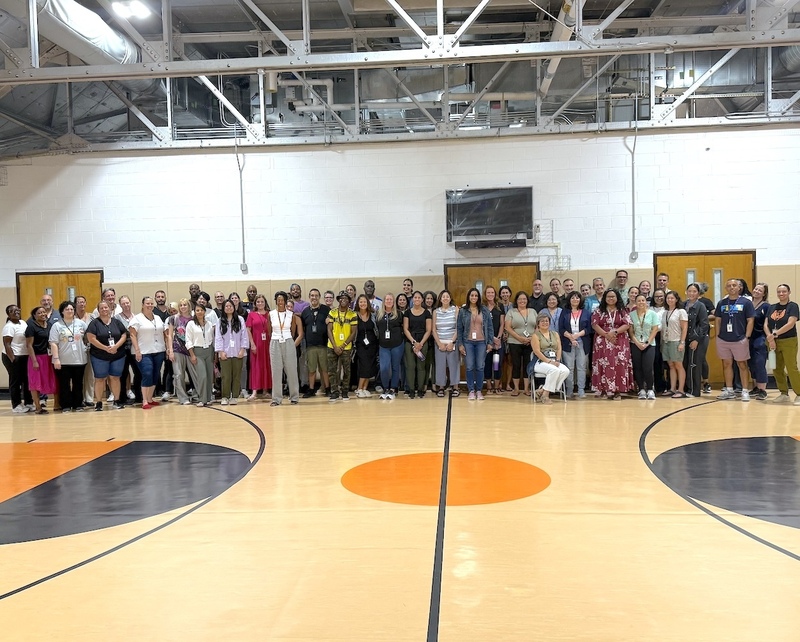 staff gathered for a wide group photo after a mixer event