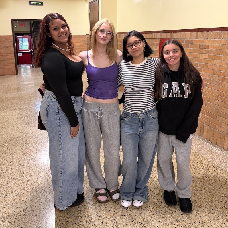 four girls in hallway smiling
