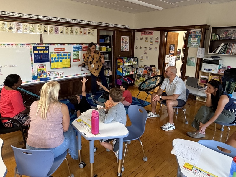 parents sit around classroom during lesson