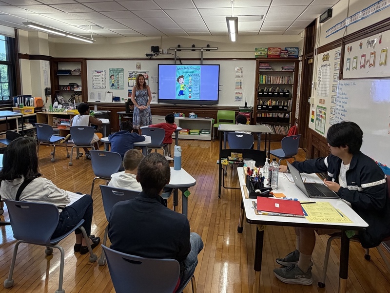 teacher leads students, families in typical lesson