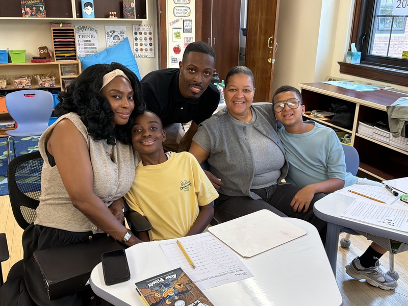 teacher and parents surround students in school