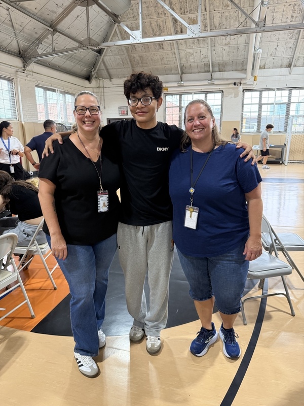 two teachers and student in the gym