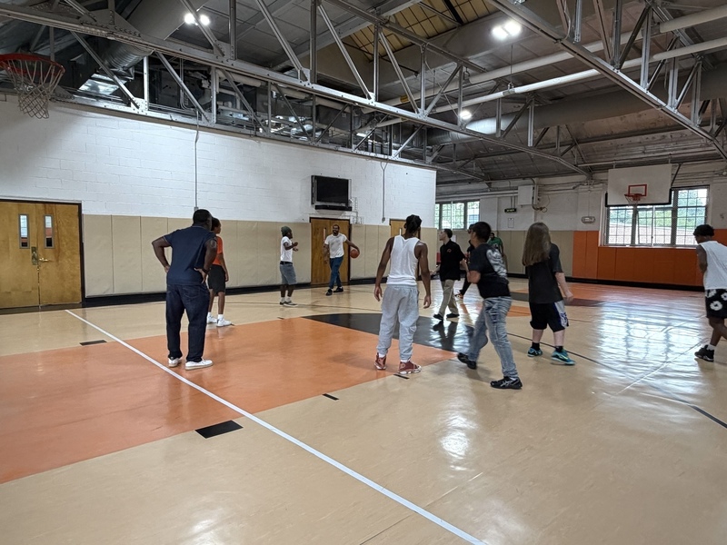 students and teachers playing basketball