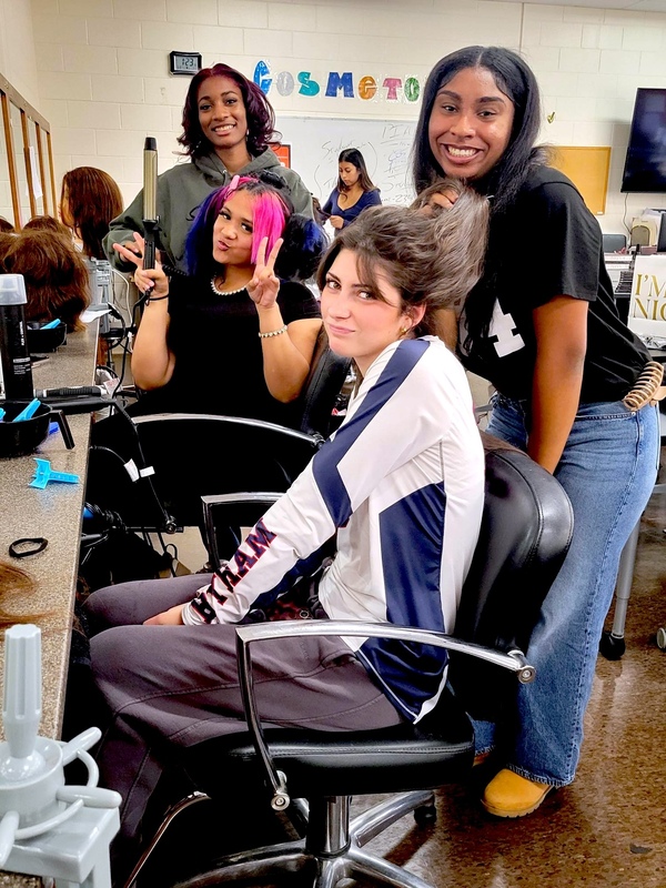 students smile during cosmetology class