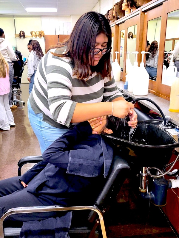 students washes hair of classmate