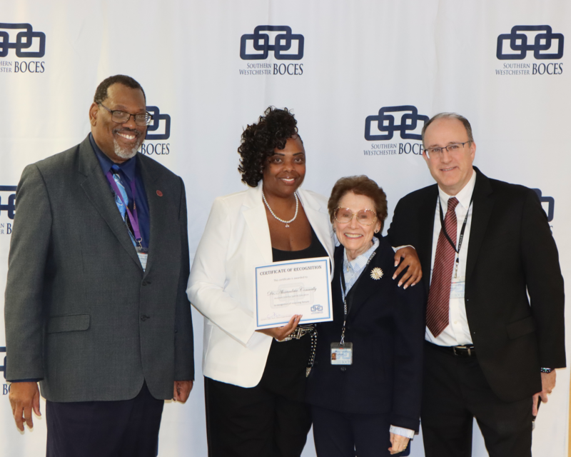 administrators and board member celebrate tenure recipient