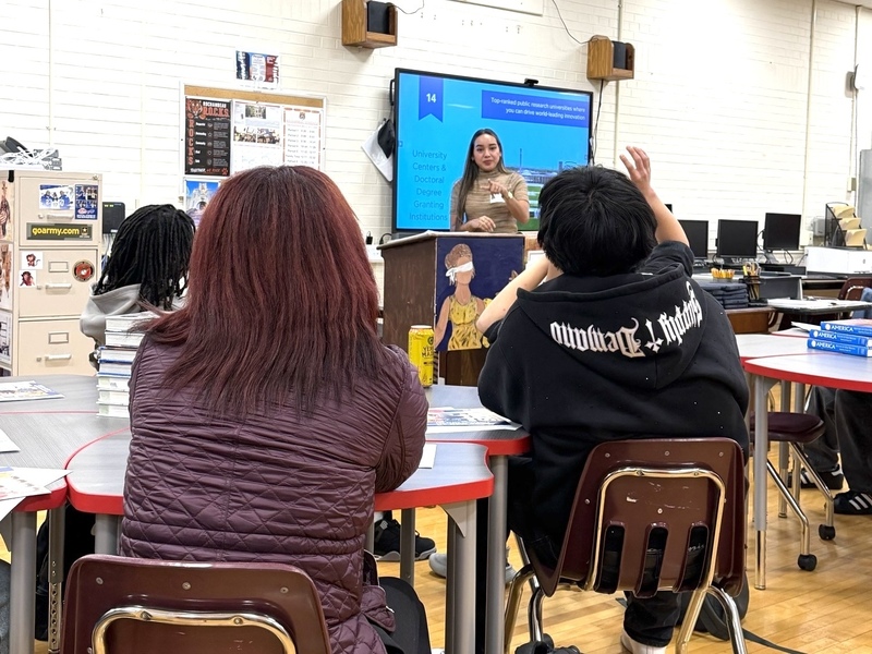two students look up at speaker
