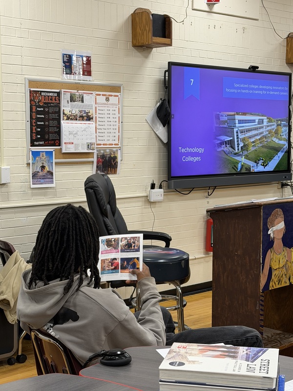 student looks at college materials