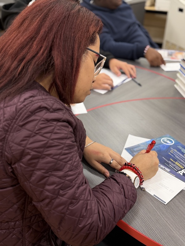 student works on college materials