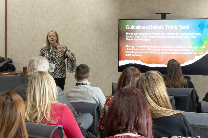 Woman standing in front of seated group of people