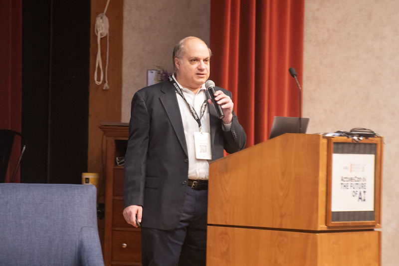 Man standing in front of a podium holding a mic