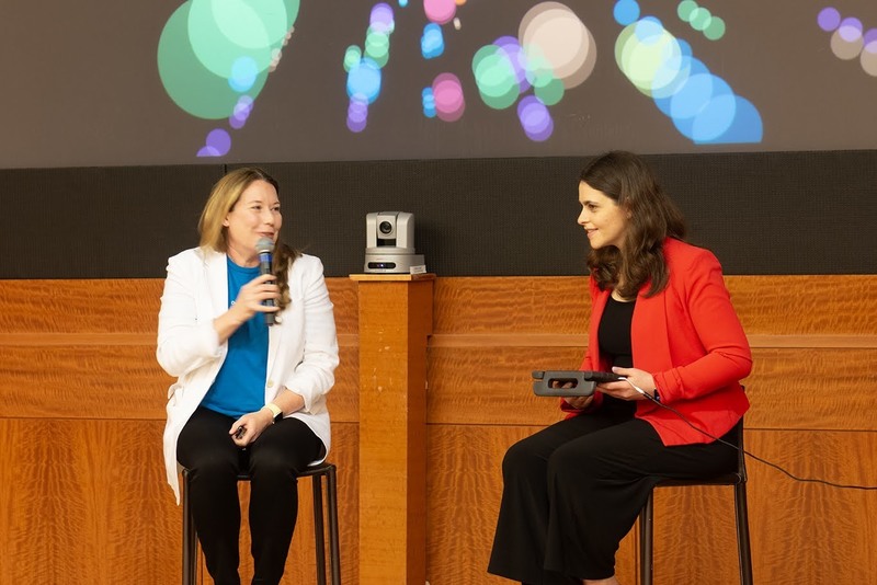 Two women sitting on tools