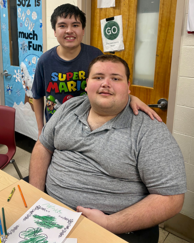 students smile together while making crafts