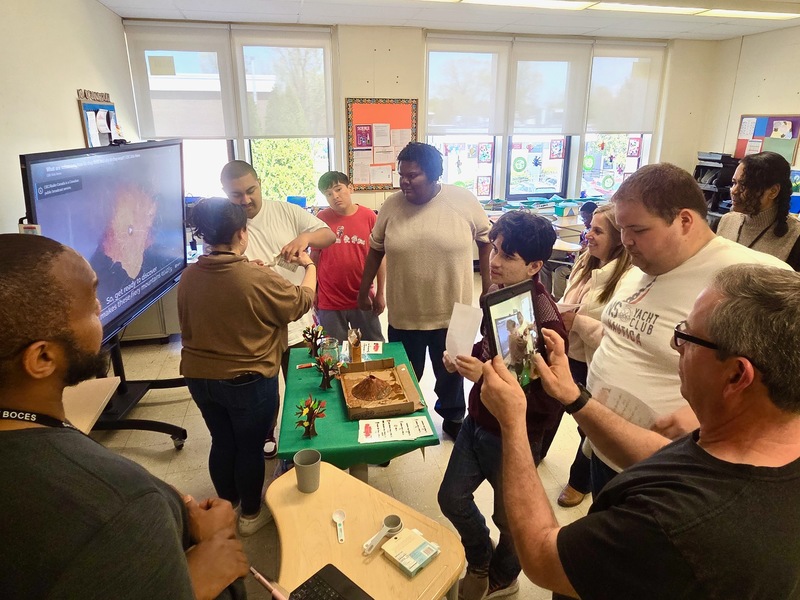 teacher explains volcano project to group