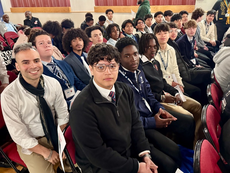 students seated waiting for symposium to begin