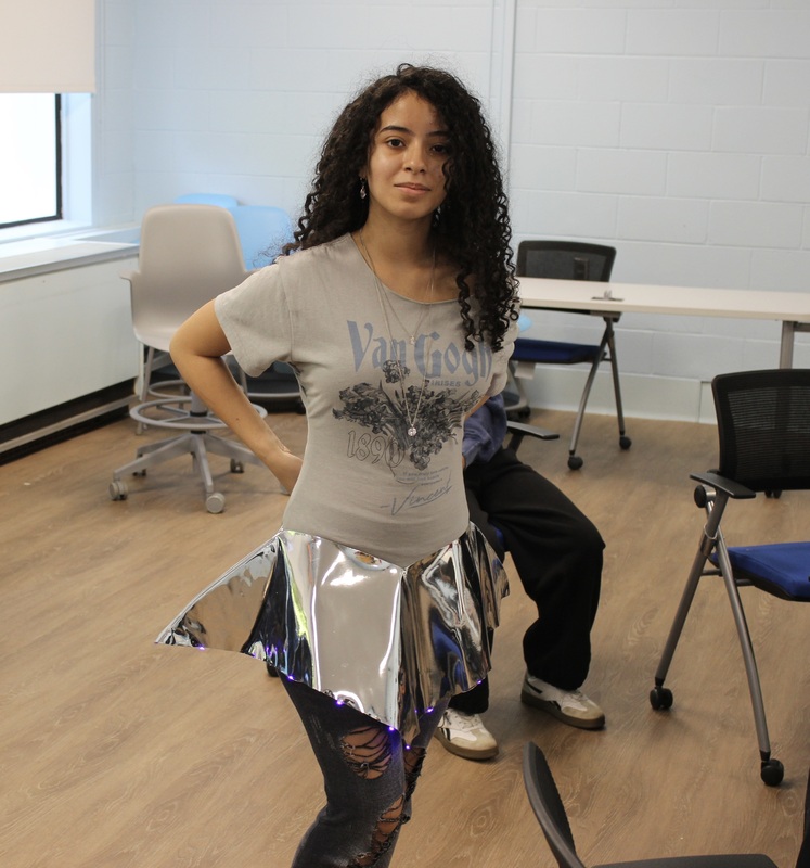 A student models her design for the upcoming fashion show.