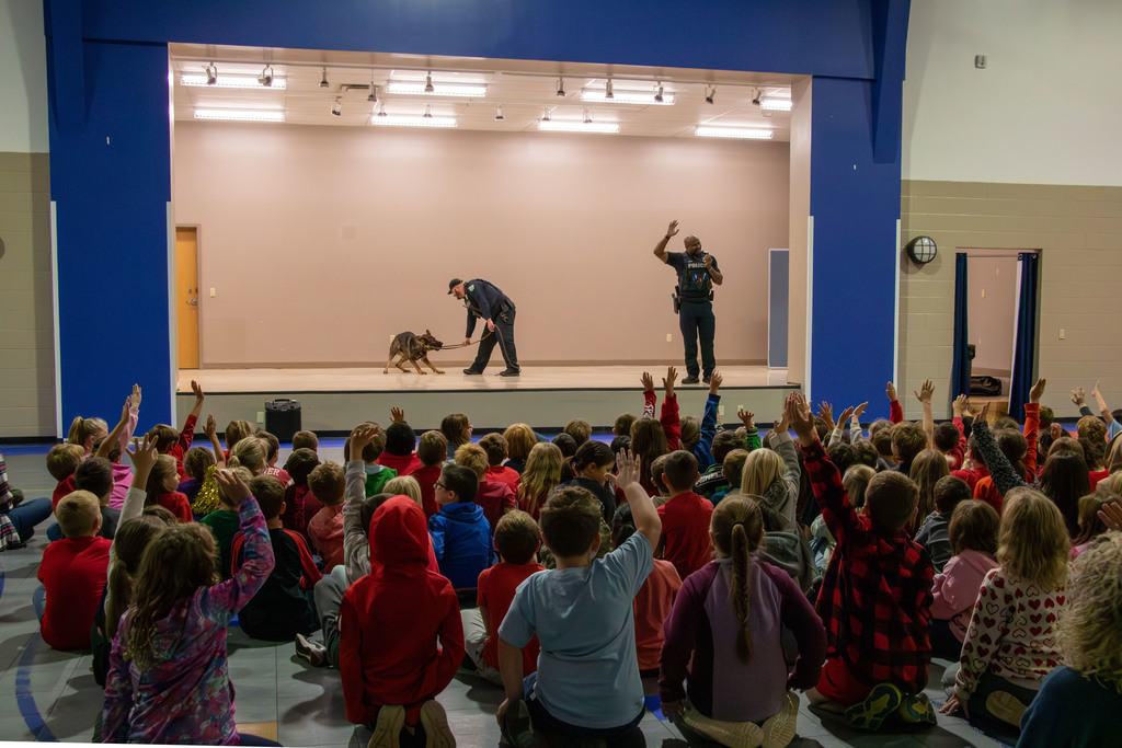 k9, officers and students with their hands raised