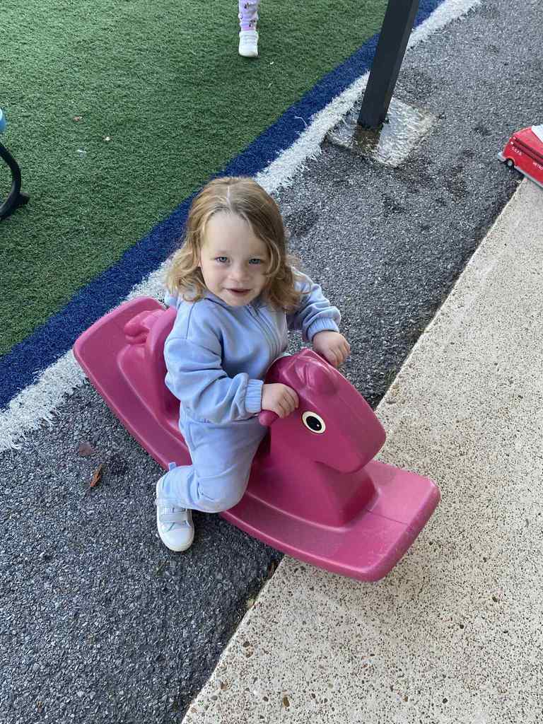 child on rocking horse