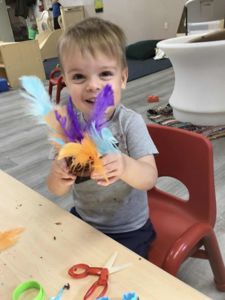 child showing playdoh turkey 