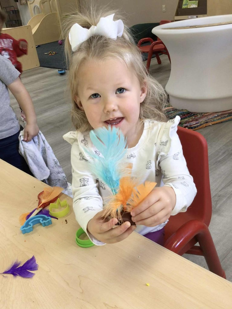 child showing playdoh turkey 