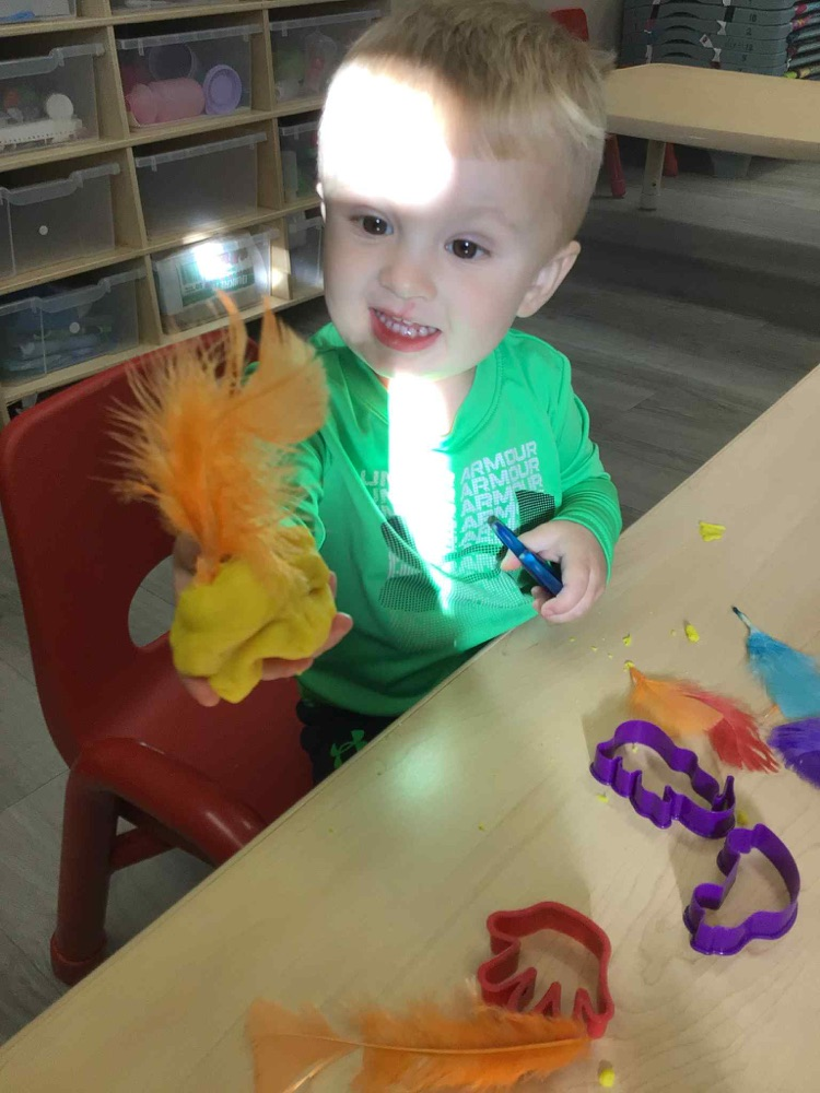 child showing playdoh turkey 