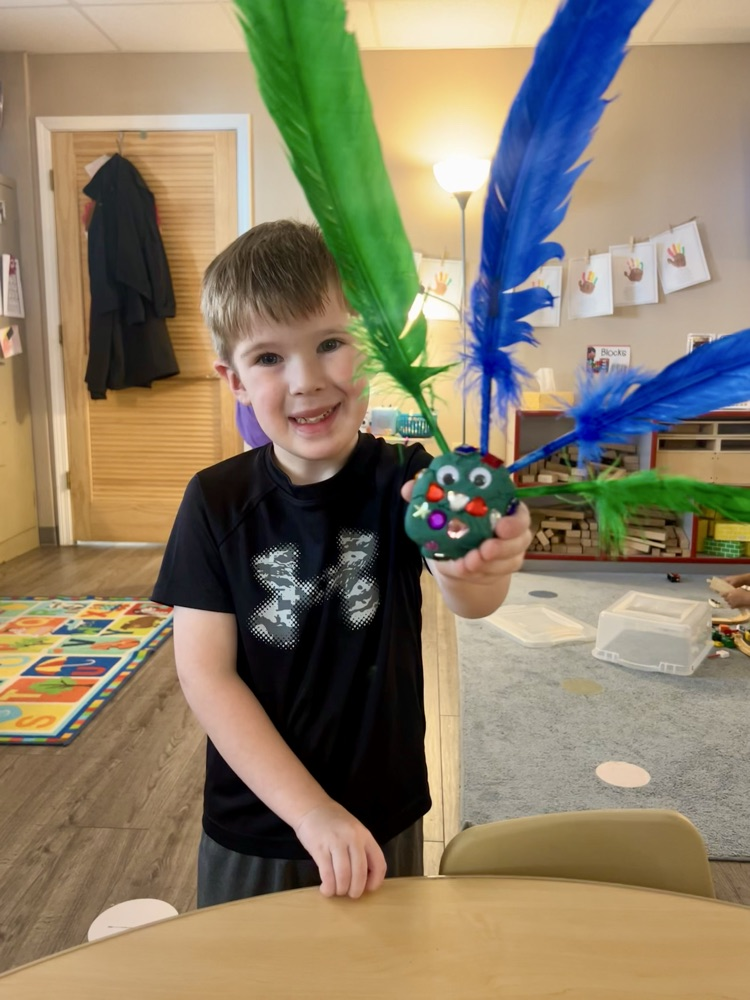 child made turkey with playdoh and feathers