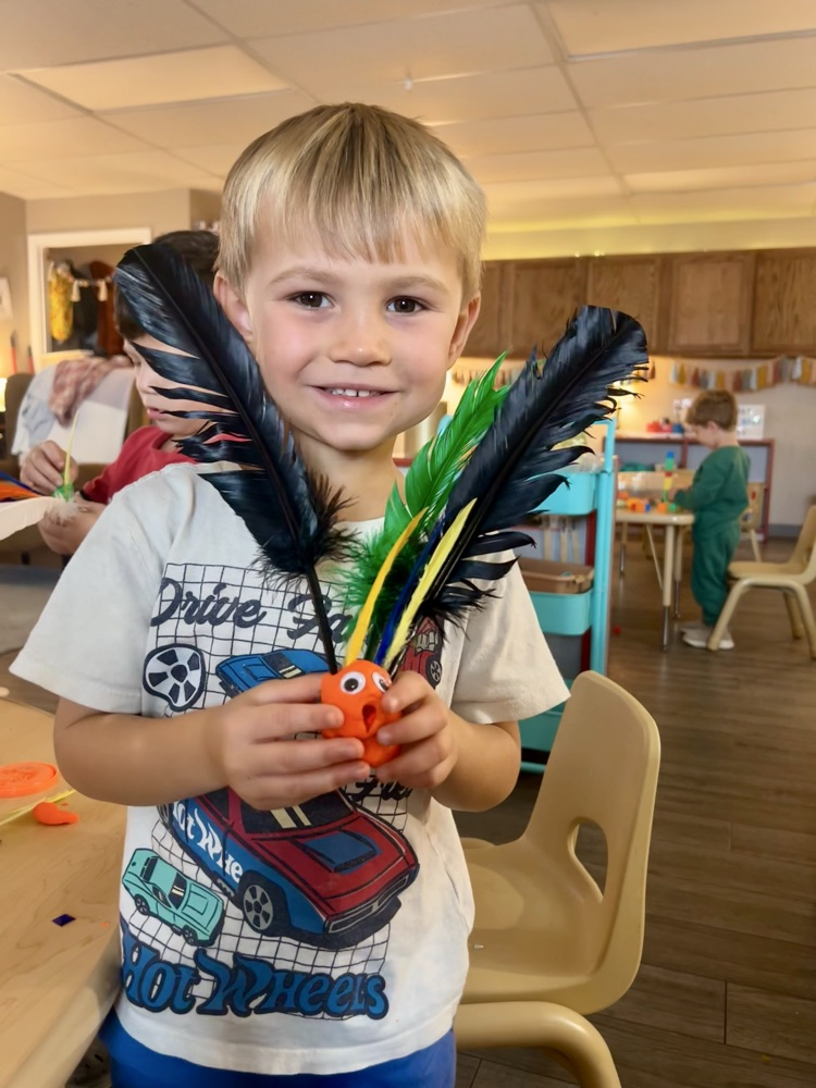 child made turkey with playdoh and feathers