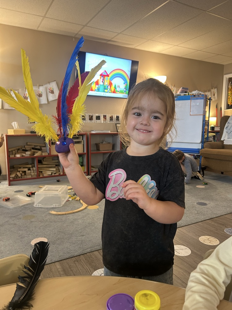 child made turkey with playdoh and feathers