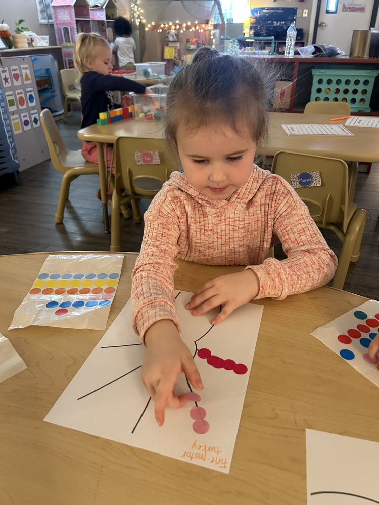 child putting stickers as turkey feathers