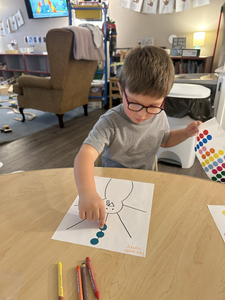 child putting stickers as turkey feathers