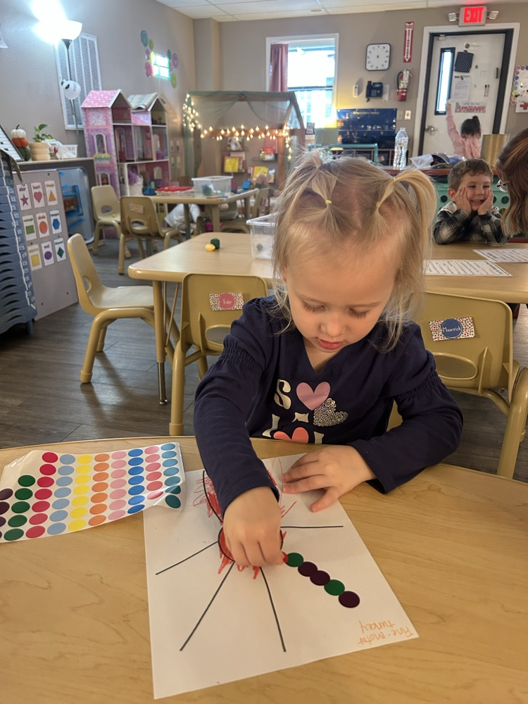 child putting stickers as turkey feathers 