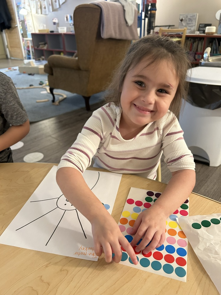 child putting stickers as turkey feathers 