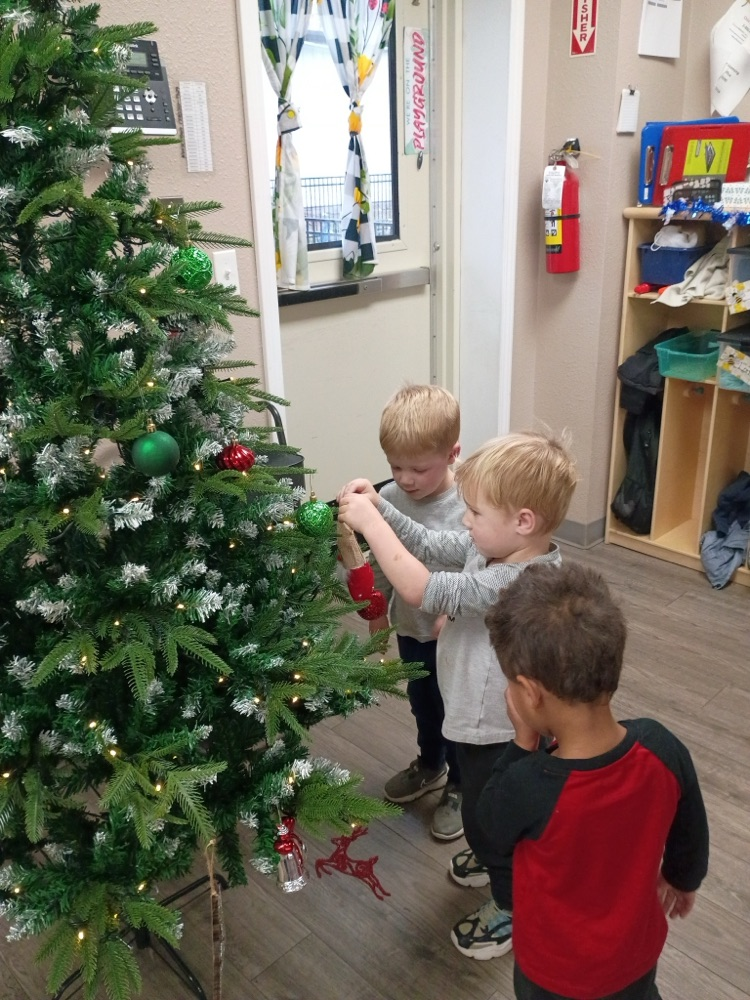 children decorating Christmas tree