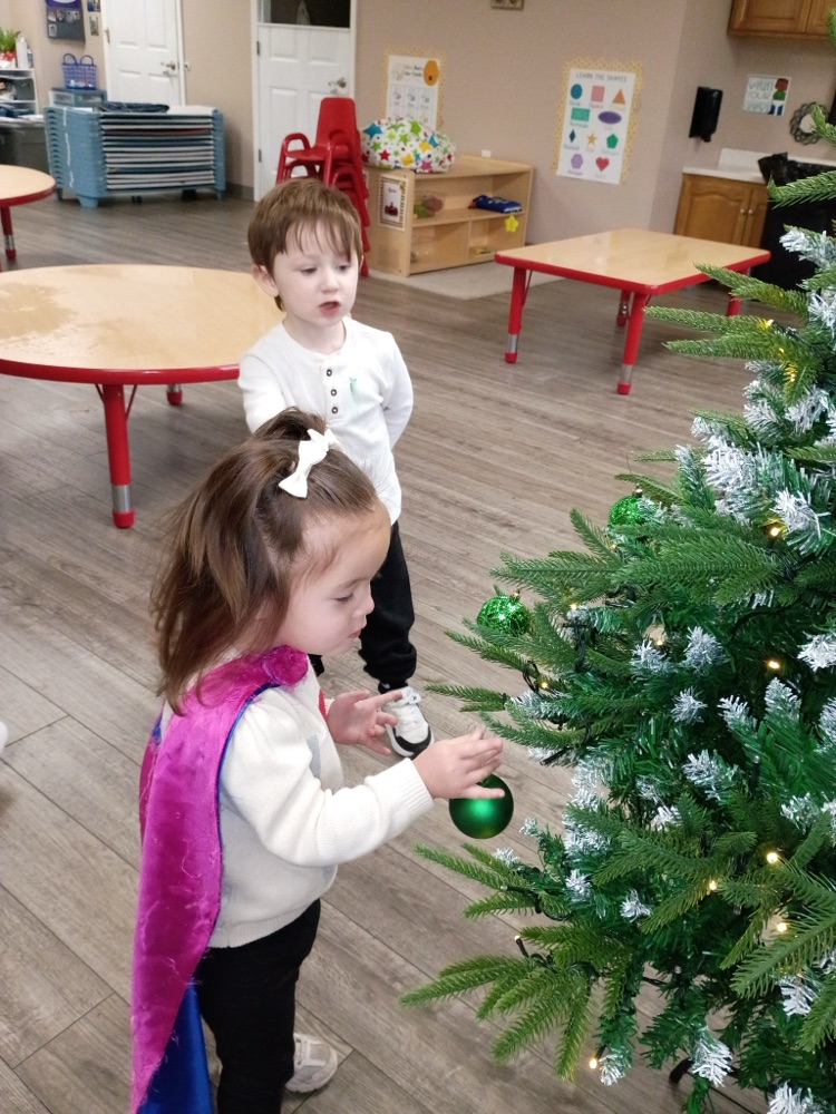 children decorating Christmas tree