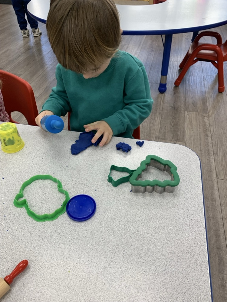 child playing with playdoh