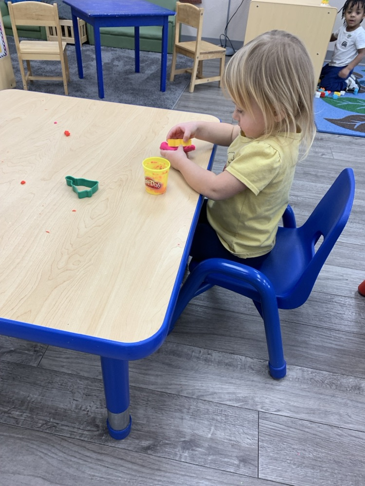 child playing with playdoh