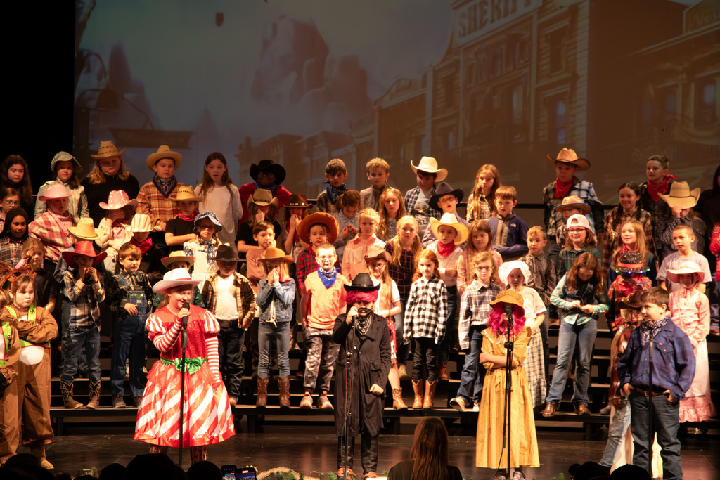 students and director on stage