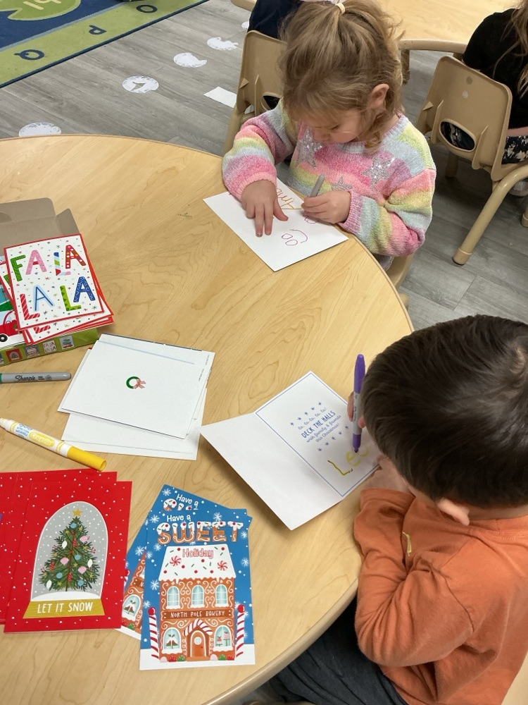 children practicing writing names