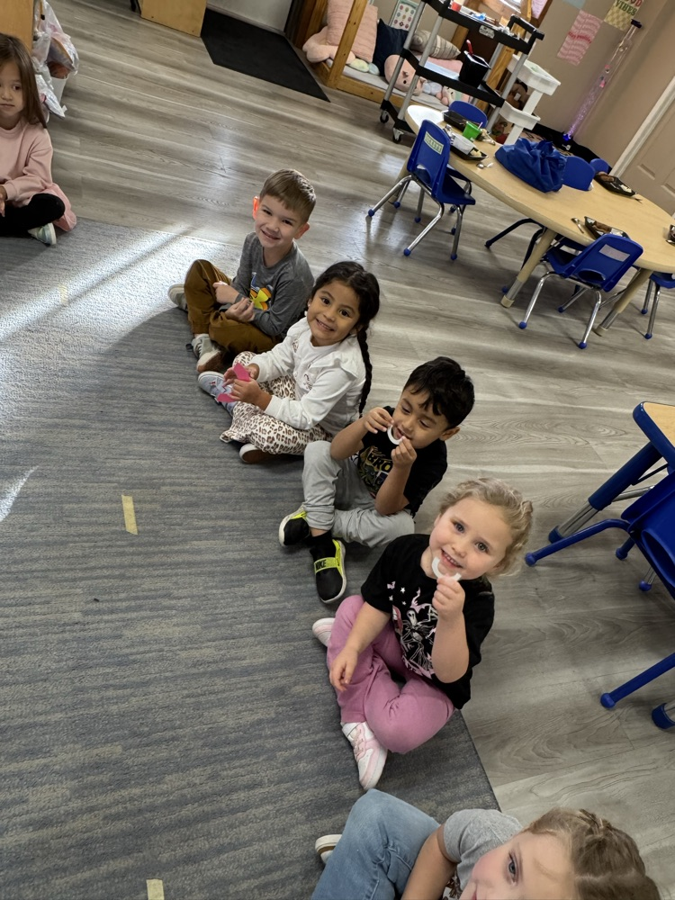 children holding up paper body parts and smiling